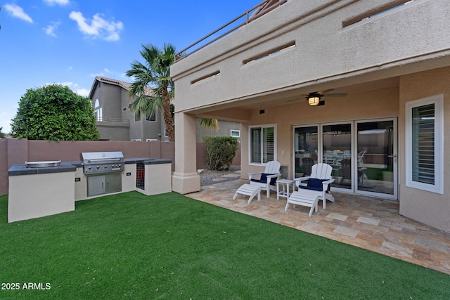 view of patio / terrace with area for grilling, a grill, a ceiling fan, and fence