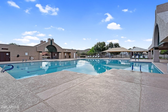 pool featuring a patio area and fence