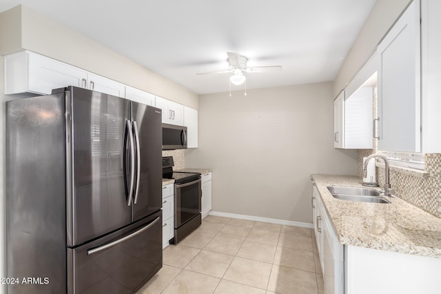 kitchen with decorative backsplash, appliances with stainless steel finishes, ceiling fan, sink, and white cabinets