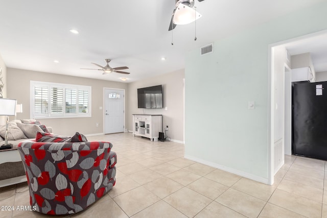 tiled living room featuring ceiling fan