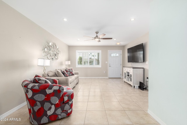 living room featuring ceiling fan and light tile patterned floors