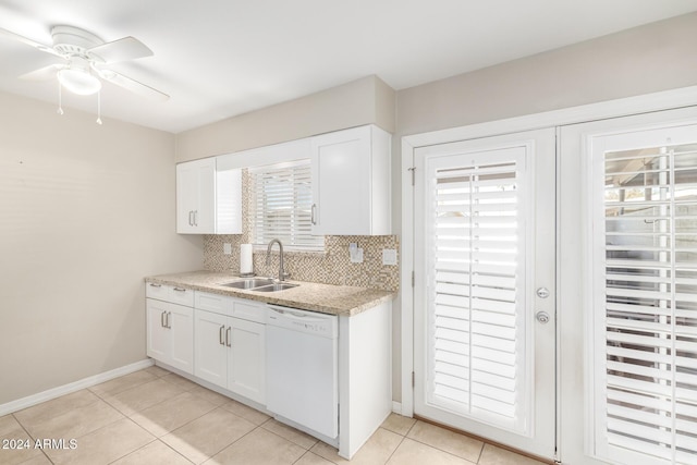 kitchen with white dishwasher, white cabinets, sink, ceiling fan, and decorative backsplash