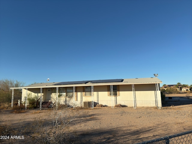 manufactured / mobile home with solar panels and central air condition unit