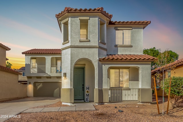 view of front of home with a balcony and a garage