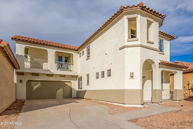 view of front of property with a garage and a balcony