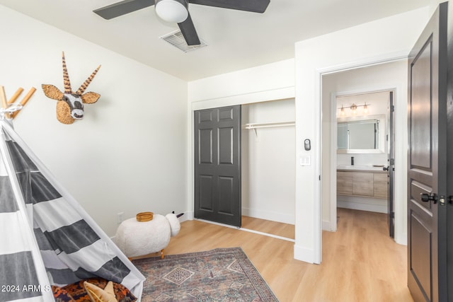 bedroom featuring light hardwood / wood-style flooring, a closet, and ceiling fan