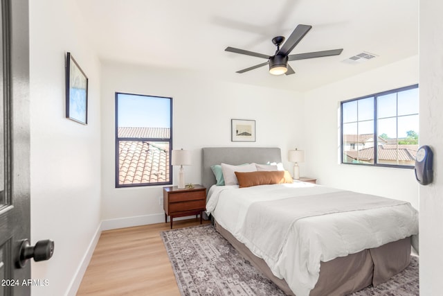 bedroom with ceiling fan and light hardwood / wood-style floors