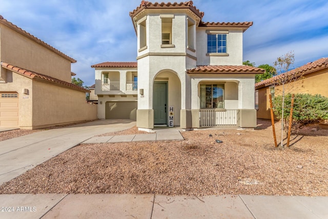 mediterranean / spanish-style house with a garage