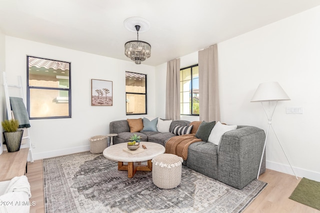 living room featuring an inviting chandelier and light hardwood / wood-style flooring