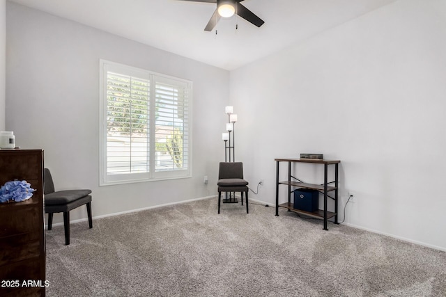 living area featuring ceiling fan and carpet