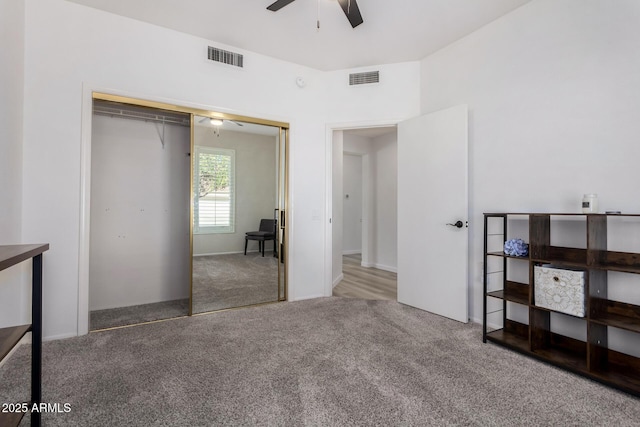 carpeted bedroom with ceiling fan and a closet