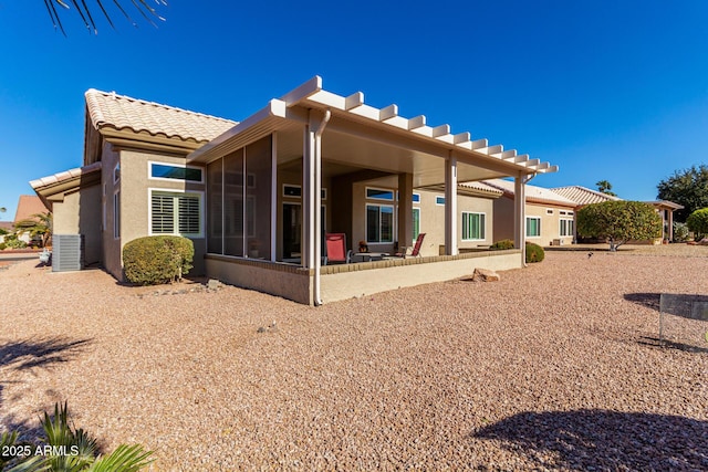 rear view of house featuring cooling unit, a patio, and a sunroom