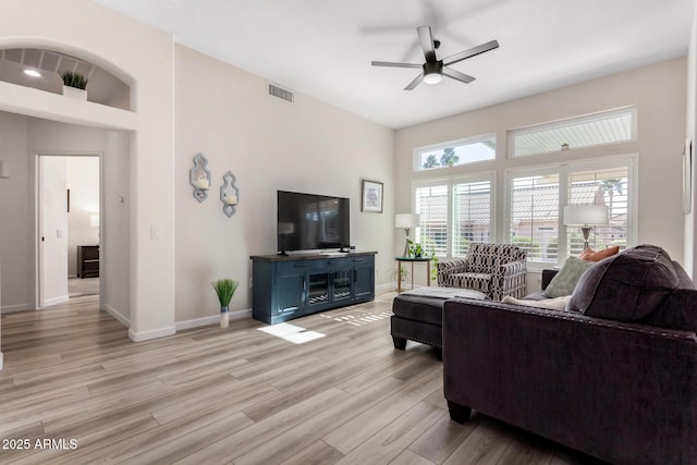 living room with light hardwood / wood-style floors and ceiling fan