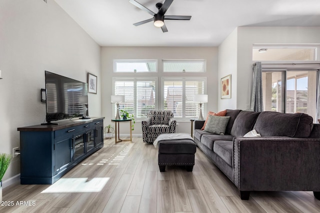 living room featuring light hardwood / wood-style floors and ceiling fan