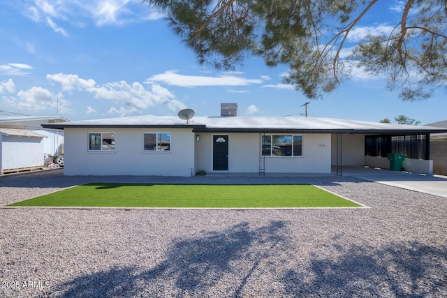 single story home featuring driveway, a front lawn, and a carport