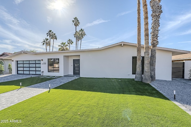 contemporary home with a garage and a front yard