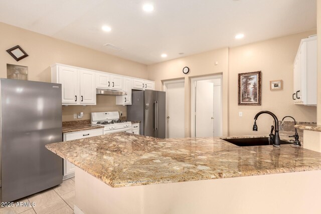 13001 W Bloomfield Rd, El Mirage, AZ 85335 - kitchen featuring white range with gas cooktop, under cabinet range hood, a sink, high end refrigerator, and freestanding refrigerator