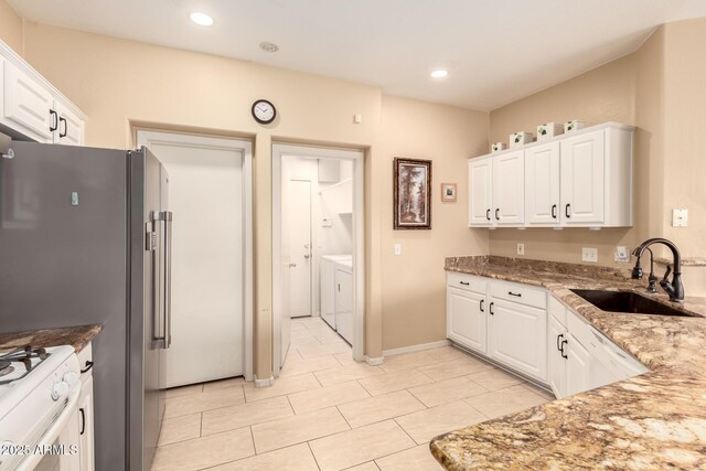 13001 W Bloomfield Rd, El Mirage, AZ 85335 - kitchen featuring washing machine and dryer, white cabinets, and a sink