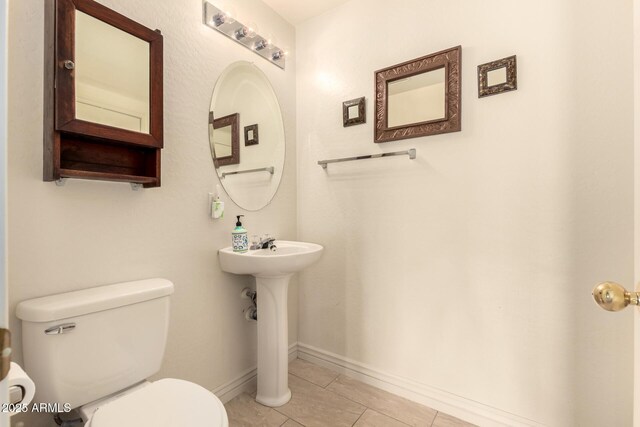 13001 W Bloomfield Rd, El Mirage, AZ 85335 - half bathroom with tile patterned floors, toilet, and baseboards