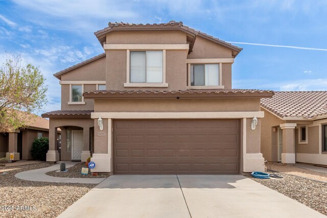 13001 W Bloomfield Rd, El Mirage, AZ 85335 - mediterranean / spanish-style house featuring stucco siding, an attached garage, a tiled roof, and concrete driveway