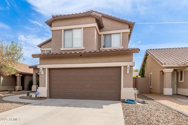 13001 W Bloomfield Rd, El Mirage, AZ 85335 - mediterranean / spanish-style home featuring stucco siding, an attached garage, a tile roof, and driveway
