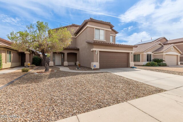 13001 W Bloomfield Rd, El Mirage, AZ 85335 - mediterranean / spanish-style house with driveway, stucco siding, a tiled roof, and a garage
