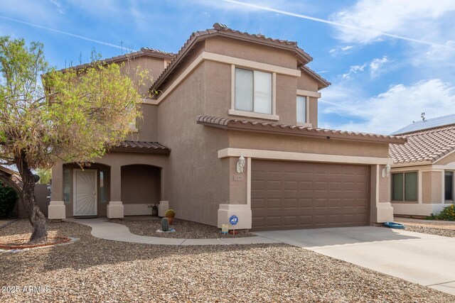 13001 W Bloomfield Rd, El Mirage, AZ 85335 - mediterranean / spanish-style house featuring stucco siding, a tile roof, a garage, and concrete driveway