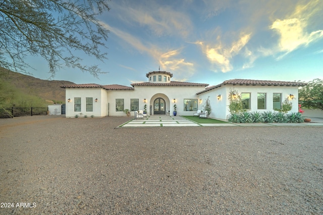 view of front of property with a patio and a mountain view