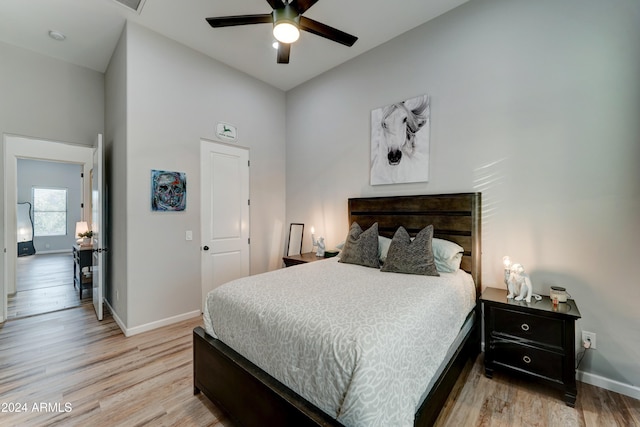 bedroom with high vaulted ceiling, light wood-type flooring, and ceiling fan