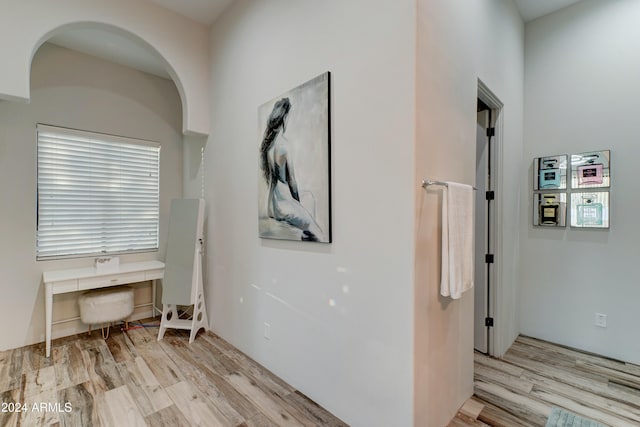 hallway with light hardwood / wood-style flooring