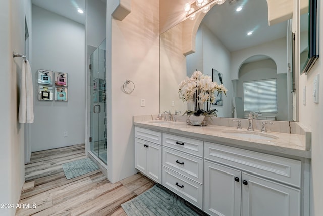 bathroom featuring vanity, wood-type flooring, and an enclosed shower