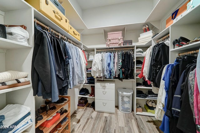 spacious closet with light hardwood / wood-style flooring