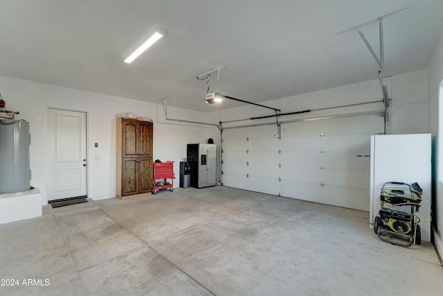 garage featuring a garage door opener, water heater, and stainless steel refrigerator with ice dispenser