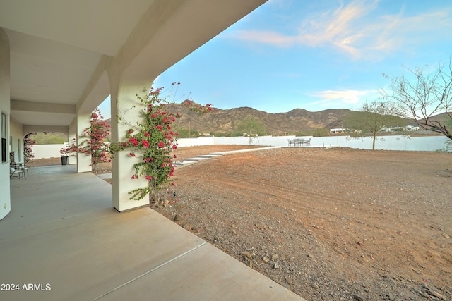 view of yard featuring a patio area and a water and mountain view