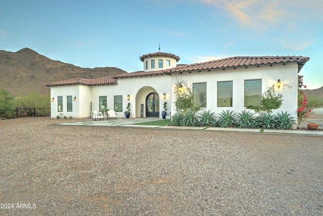 mediterranean / spanish home featuring a mountain view and a patio area