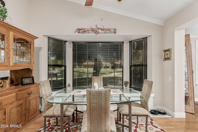 dining area with ornamental molding, lofted ceiling, ceiling fan, and light hardwood / wood-style floors