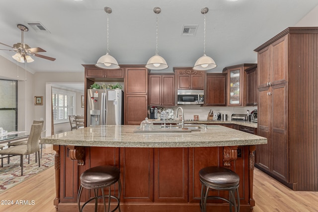 kitchen with sink, light hardwood / wood-style flooring, ceiling fan, and stainless steel appliances