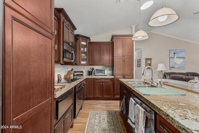 kitchen with pendant lighting, light wood-type flooring, stainless steel appliances, sink, and lofted ceiling