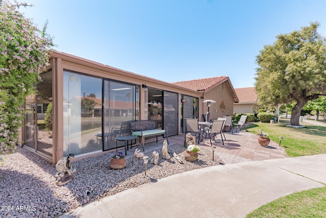 rear view of property featuring a patio