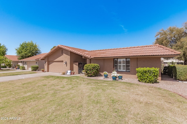 single story home with a garage and a front lawn