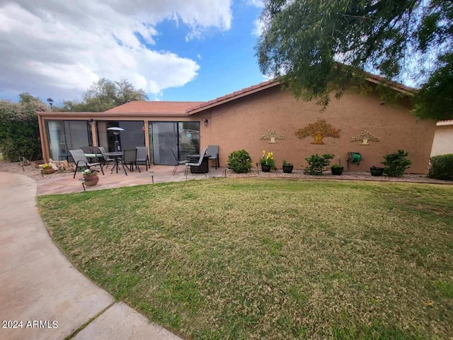 exterior space with a patio and a yard