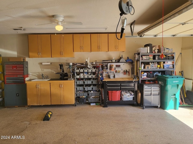 garage with sink, ceiling fan, and a workshop area