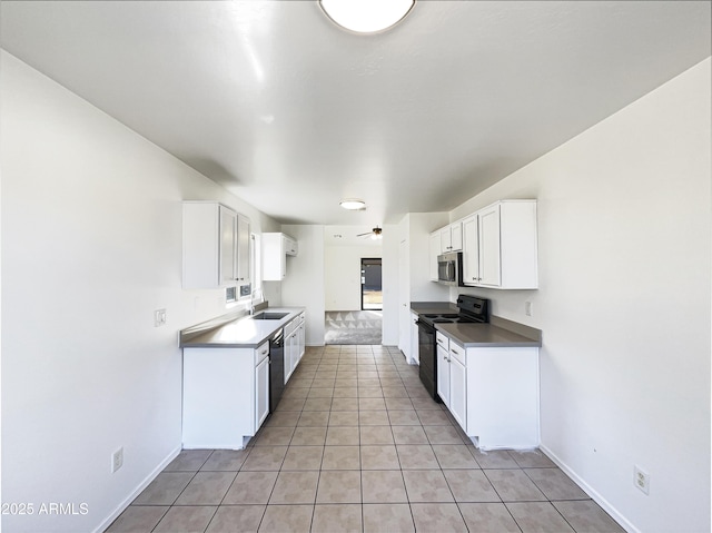 kitchen with ceiling fan, sink, white cabinets, light tile patterned flooring, and black appliances