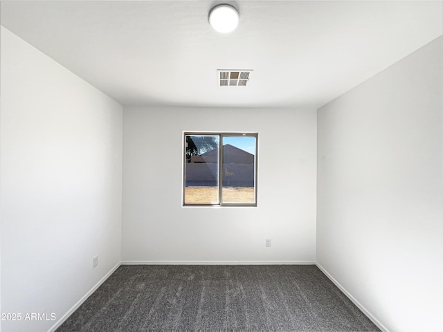 empty room featuring dark colored carpet