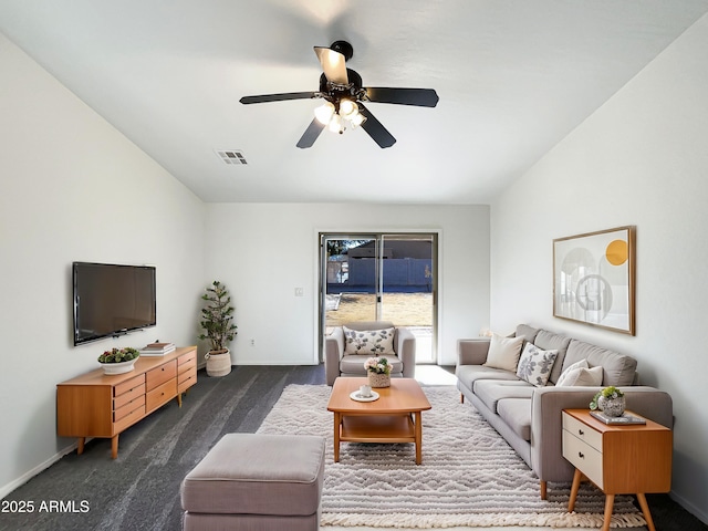 living room with ceiling fan and dark carpet