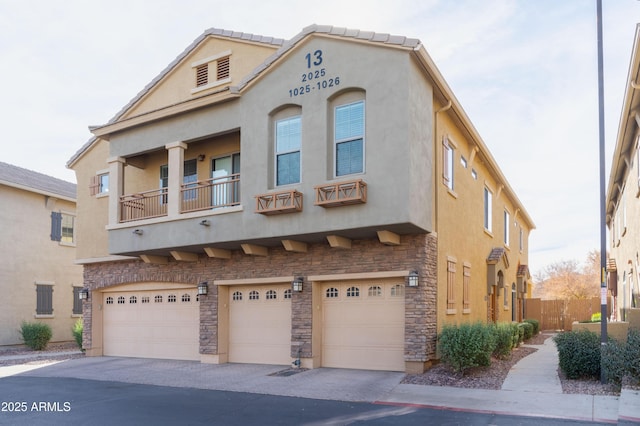 view of front of house featuring a garage and a balcony