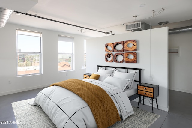 bedroom featuring concrete floors