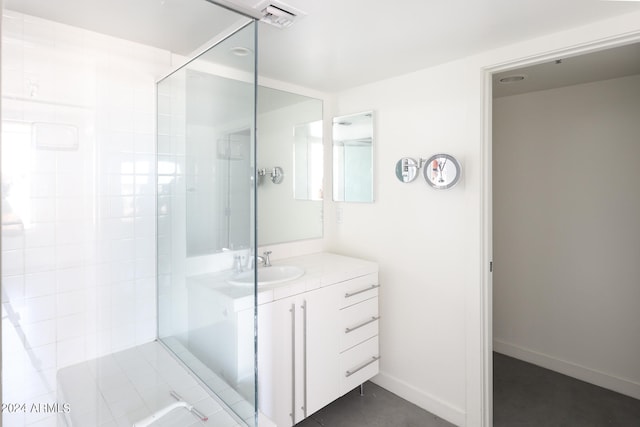 bathroom featuring vanity and tiled shower