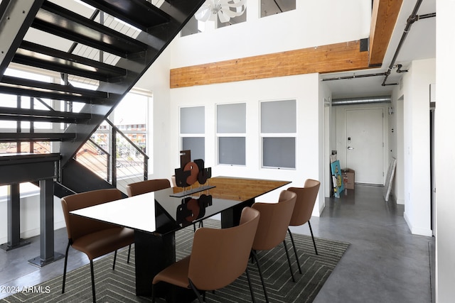 dining room featuring a high ceiling and ceiling fan