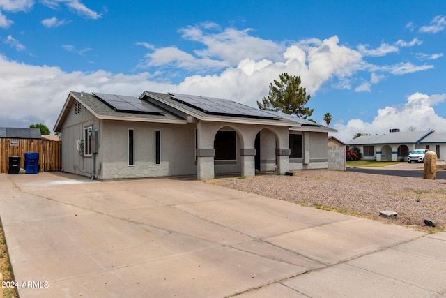 5702 S Beck Ave, Tempe, AZ 85283 - ranch-style house featuring concrete driveway, roof mounted solar panels, and covered porch